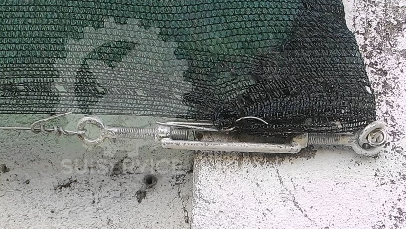 Tensor de cable para mantener la tela tensa.
